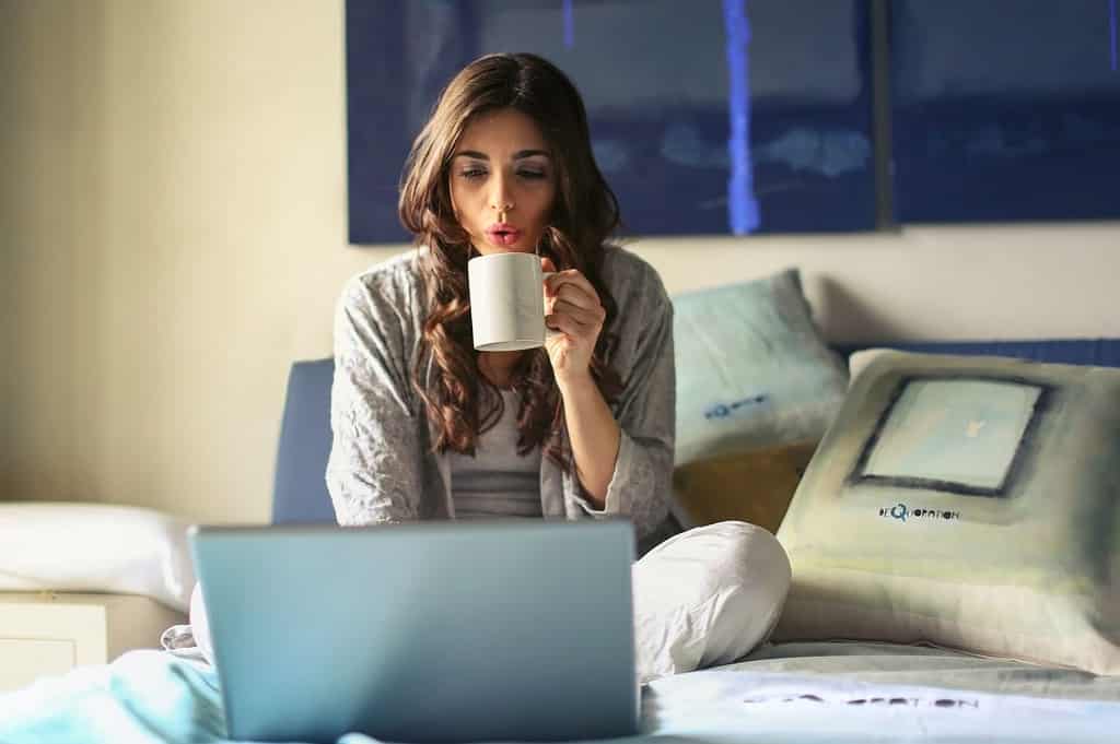 A lady enjoying her coffee while working at home