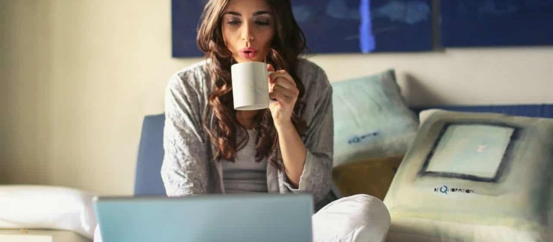 A lady enjoying her coffee while working at home